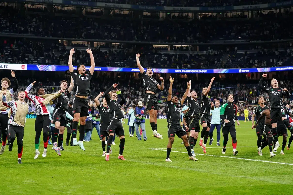 Arsenal players celebrate after the UEFA Champions League quarter-final, second leg match at the Santiago Bernabeu in Madrid, Spain.